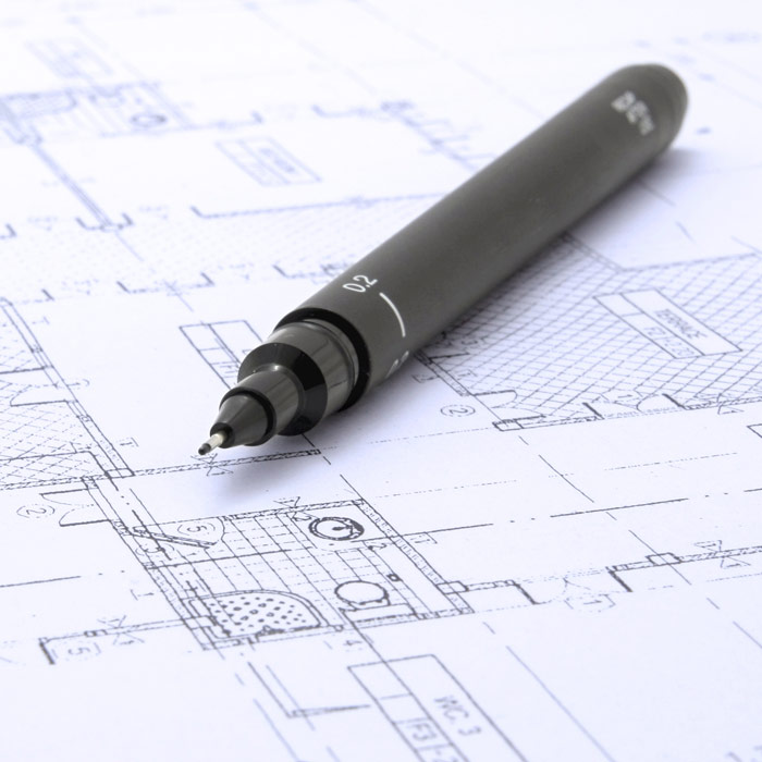Photo of a drafting pencil laying on blueprints